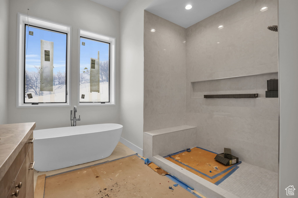 Bathroom with a wealth of natural light, vanity, and independent shower and bath