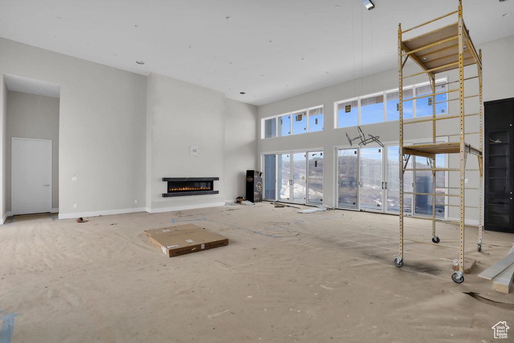 Unfurnished living room with a high ceiling