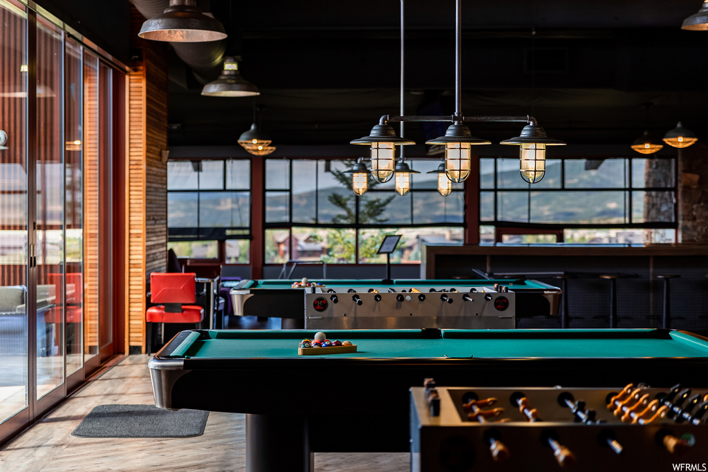 Recreation room with billiards and a healthy amount of sunlight