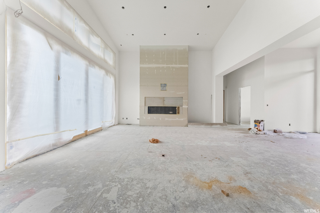 Unfurnished living room featuring a large fireplace