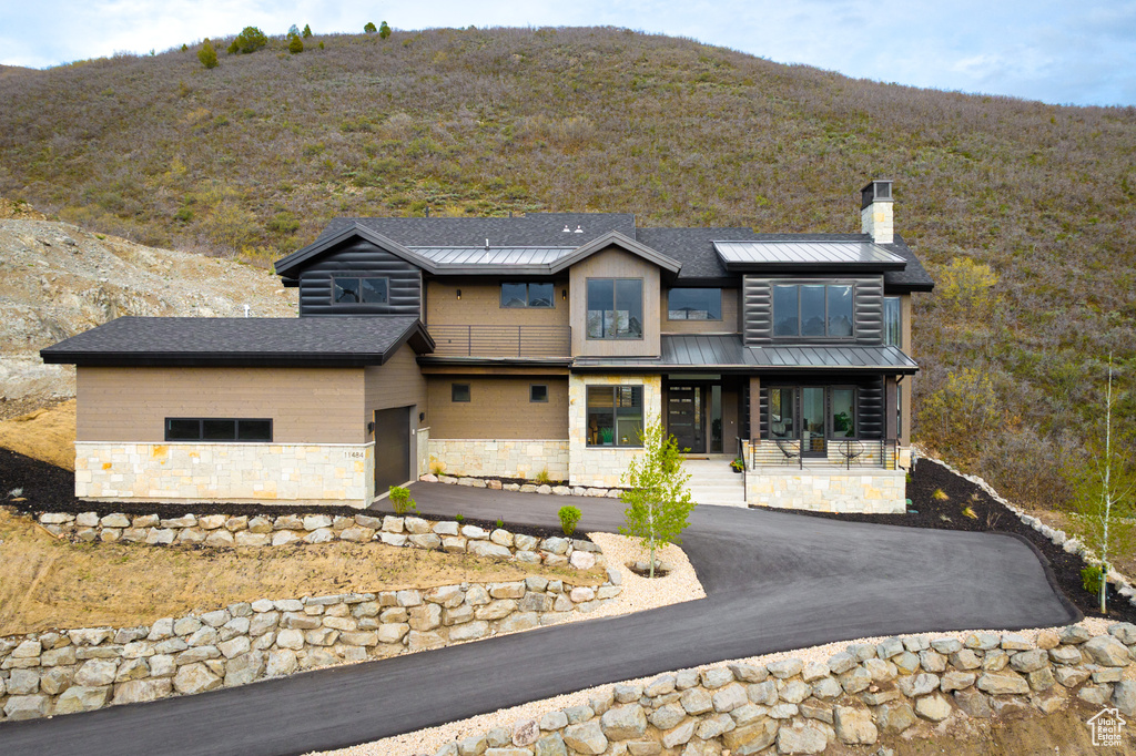 View of front of property featuring a mountain view and covered porch