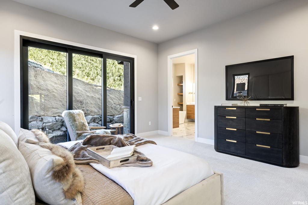 Carpeted bedroom featuring ceiling fan