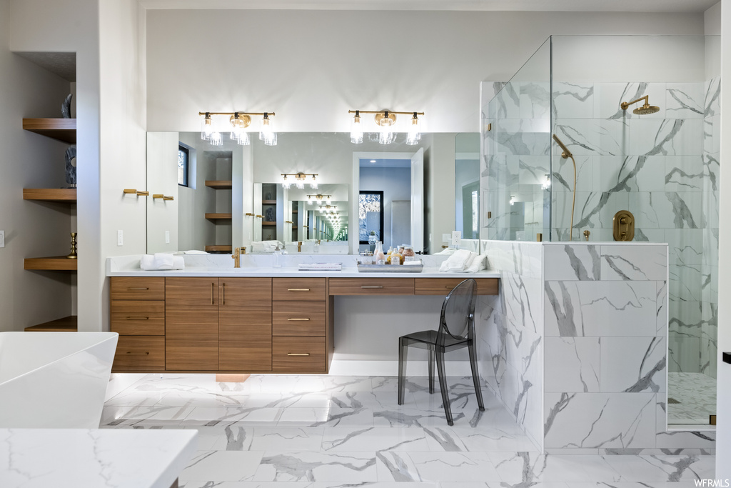 Bathroom with an enclosed shower, vanity, mirror, and light tile floors