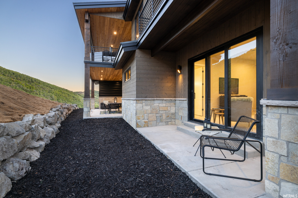 Patio terrace at dusk with balcony