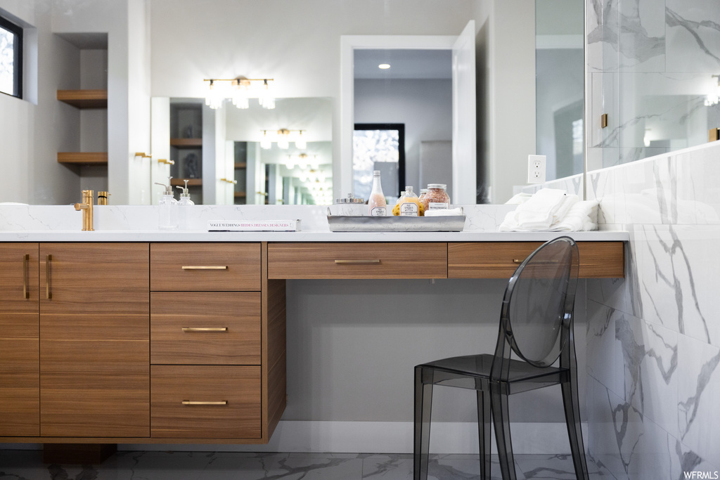 Bathroom featuring plenty of natural light, tile flooring, mirror, and large vanity