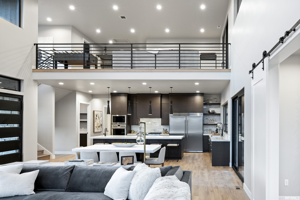 Hardwood floored living room with a high ceiling