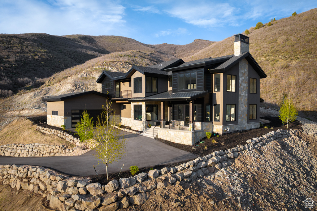 Modern home featuring a mountain view and covered porch