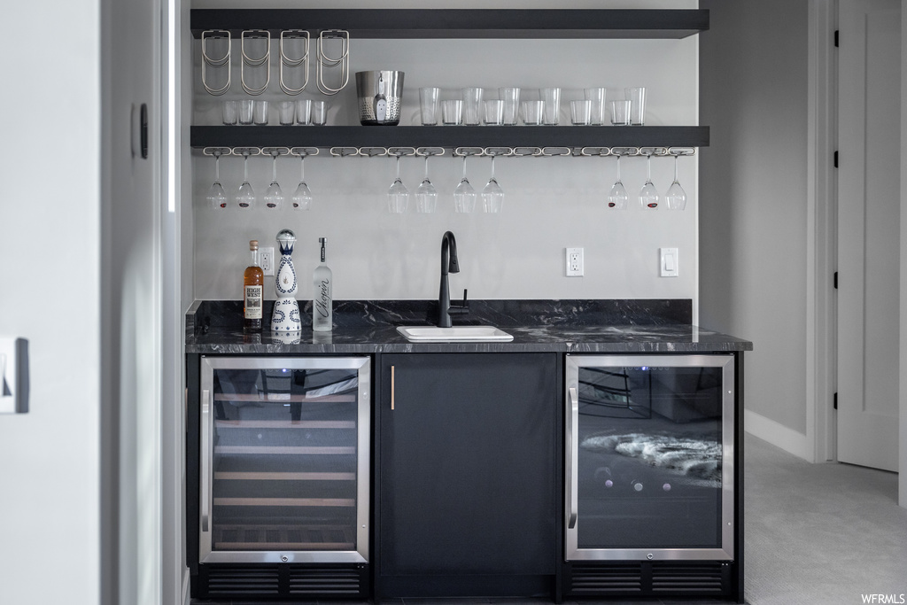 Bar with carpet and dark countertops