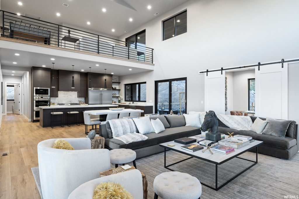 Hardwood floored living room with a high ceiling