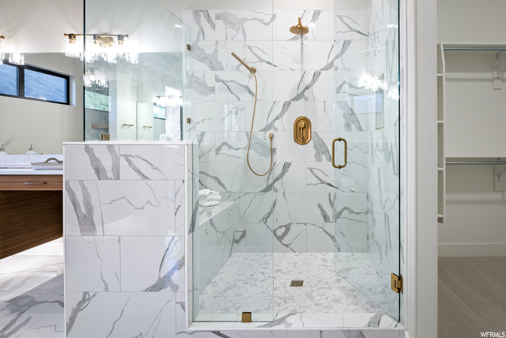 Bathroom with oversized vanity, mirror, and a shower with door