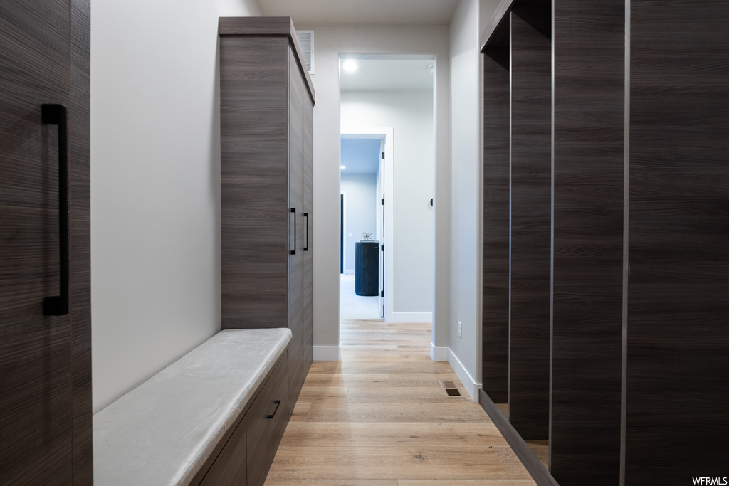 Hallway featuring light hardwood flooring