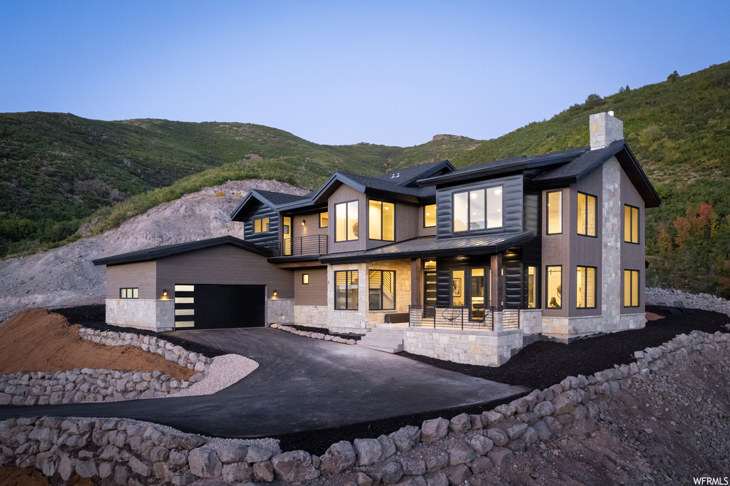 Back of property featuring a mountain view and garage