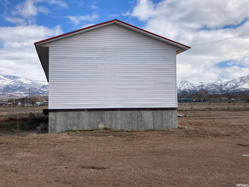 view of property exterior with a mountain view