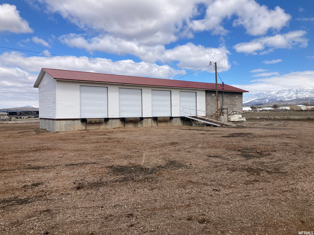 back of house featuring a mountain view