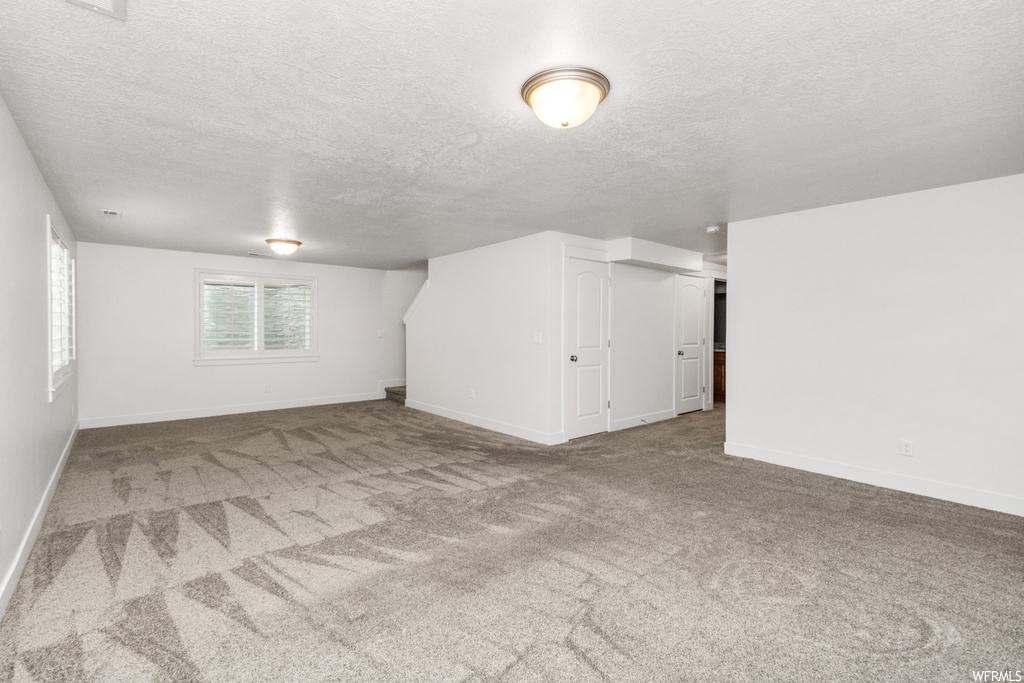 basement with carpet and natural light