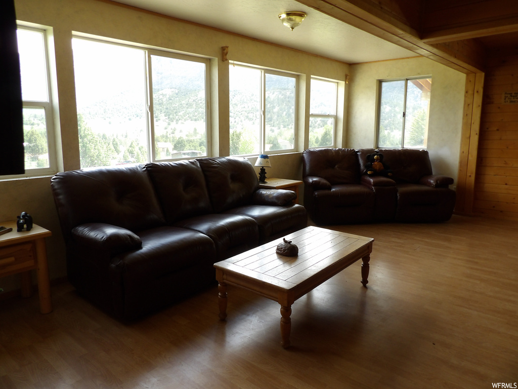 Hardwood floored living room featuring natural light