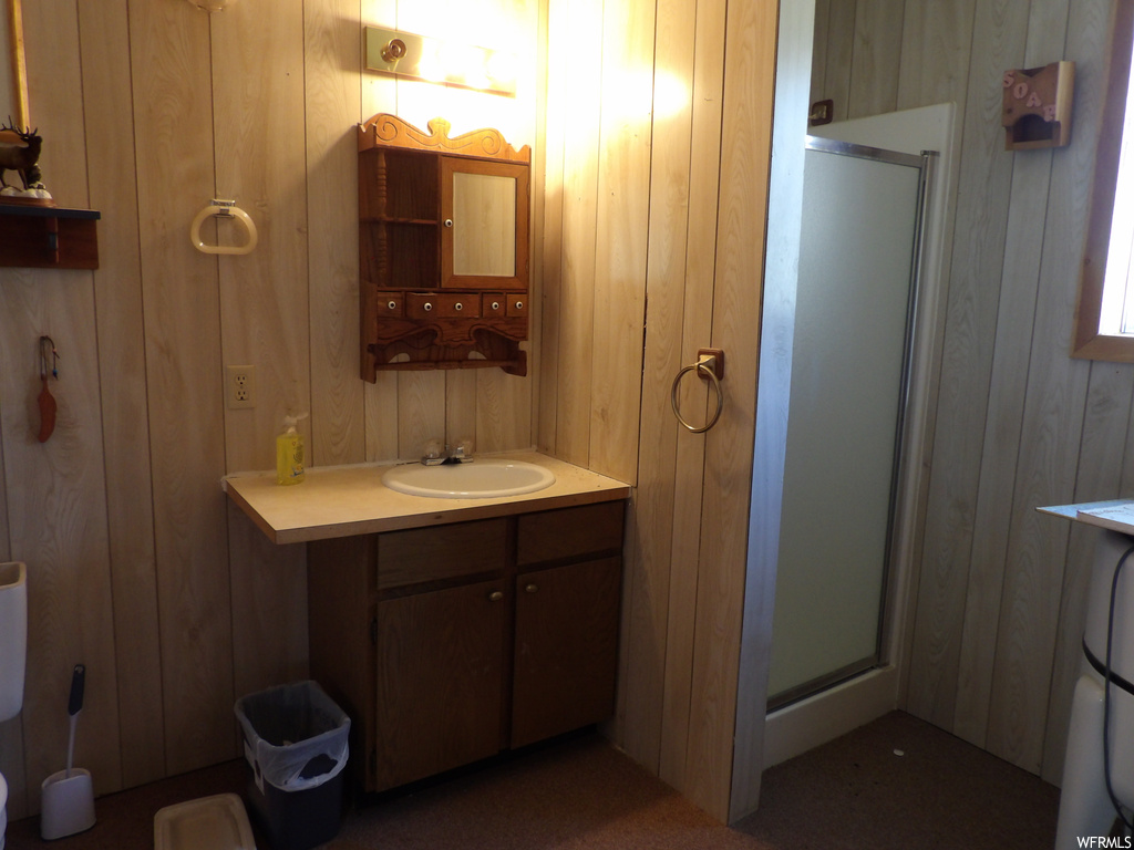Bathroom featuring mirror, shower cabin, and large vanity