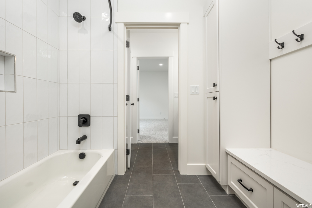 interior space featuring tile floors and shower / bath combination