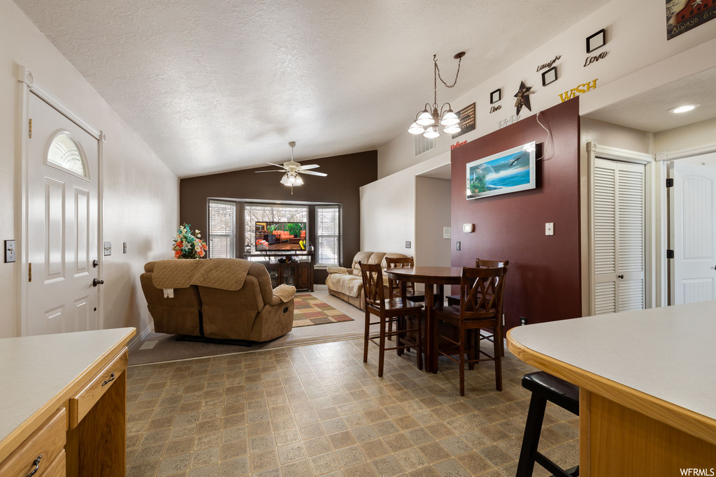 tiled dining room with a ceiling fan and TV