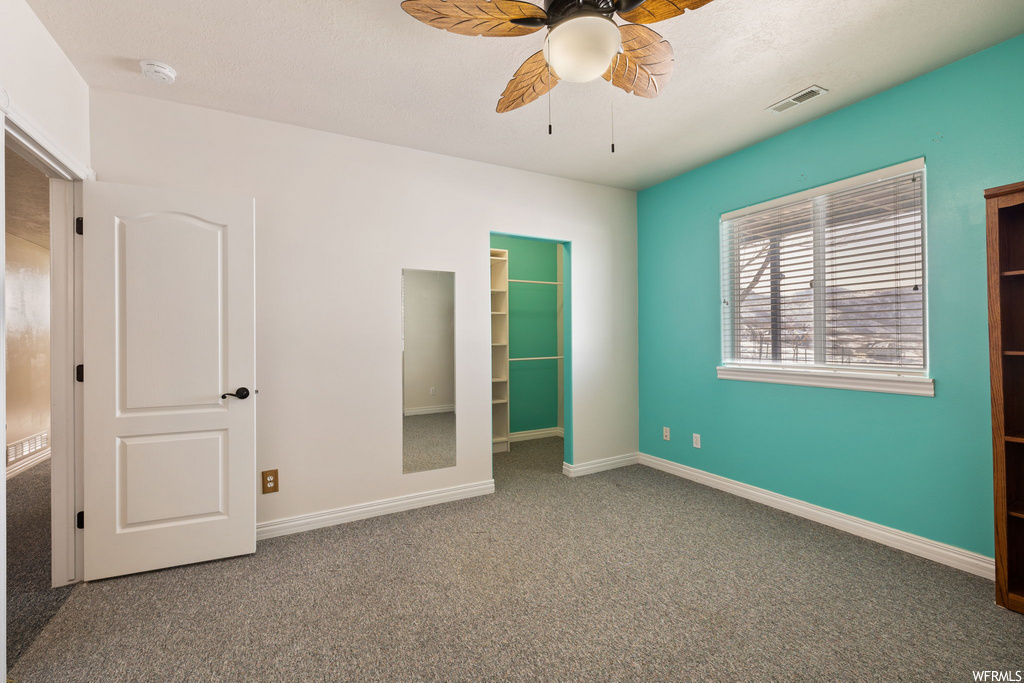 bedroom with natural light, carpet, and a ceiling fan