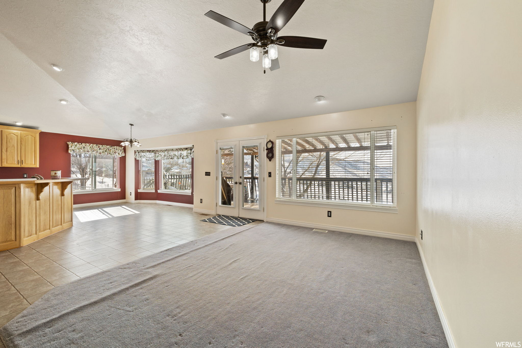 interior space with plenty of natural light, carpet, and a ceiling fan