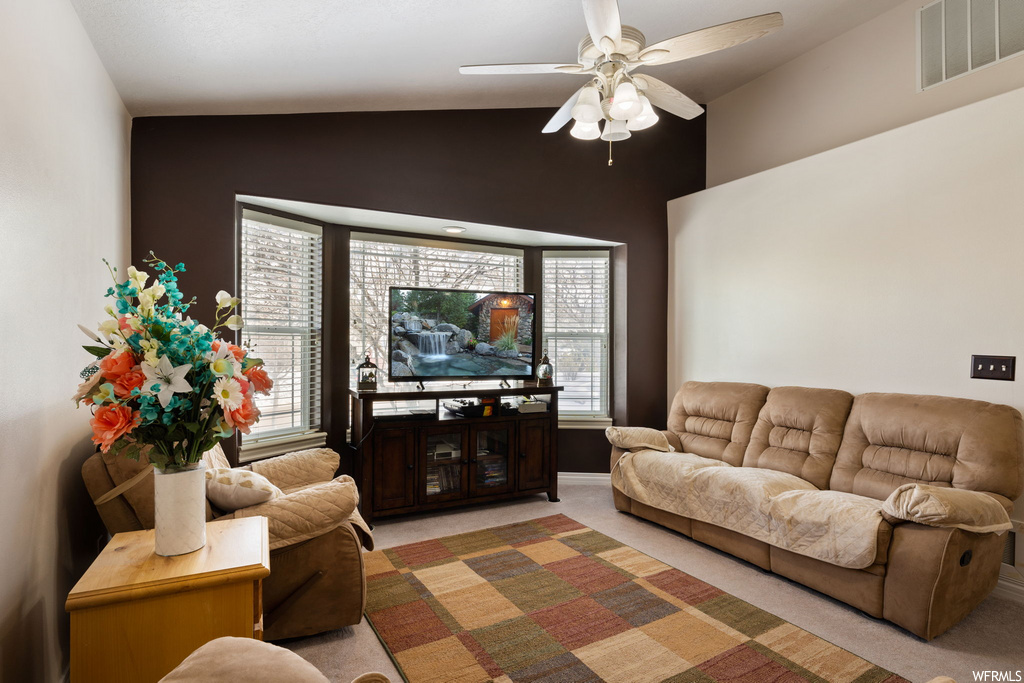 living room with carpet, natural light, a ceiling fan, and TV