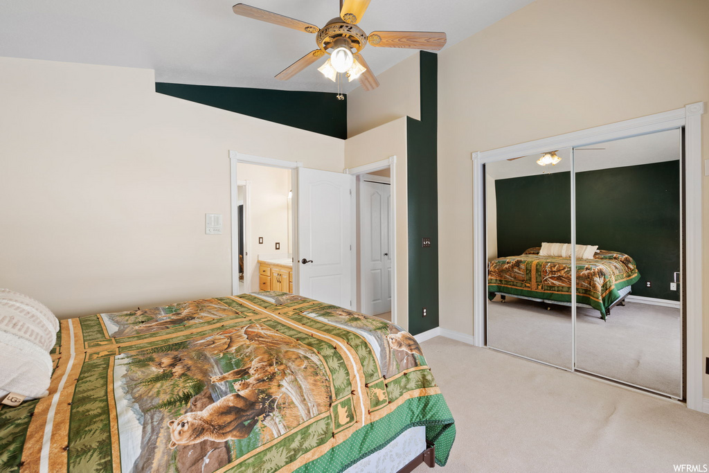 bedroom with carpet, a ceiling fan, and vaulted ceiling