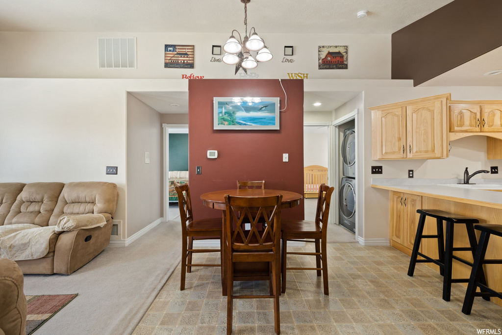 dining area featuring a kitchen breakfast bar and washer / dryer