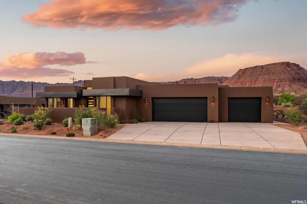 Southwest-style home with garage and a mountain view