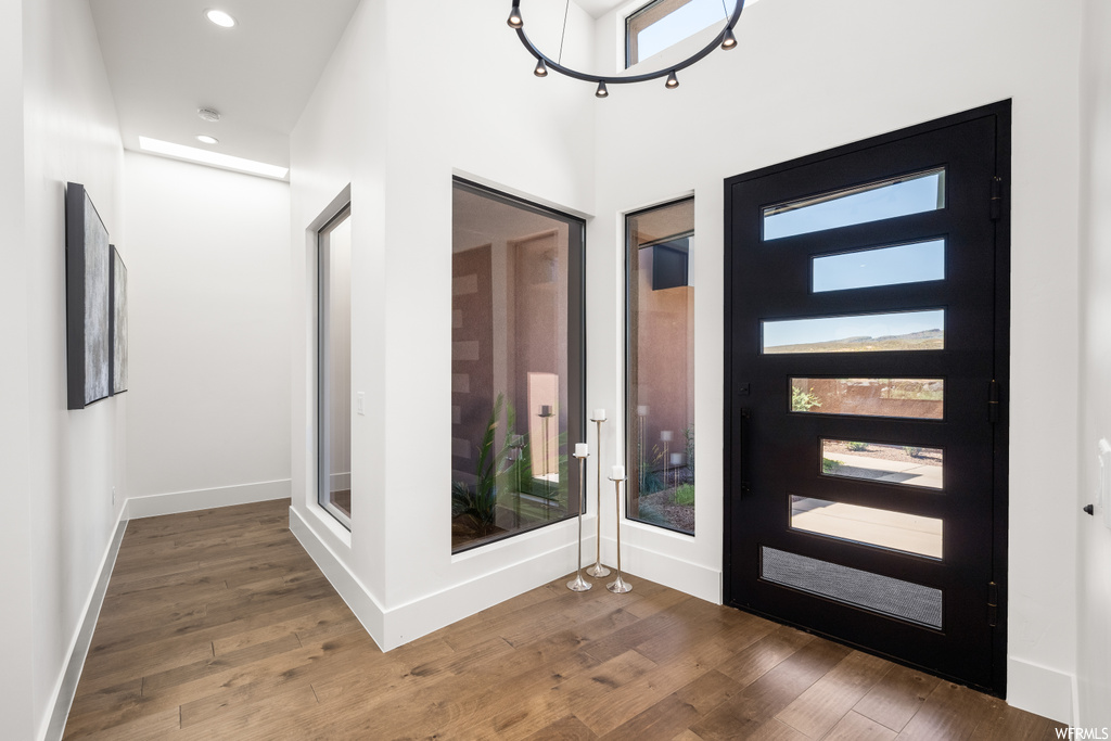 Wood floored entryway featuring french doors