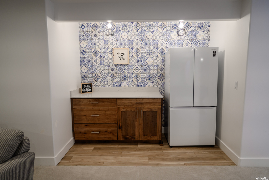 kitchen featuring refrigerator and light parquet floors