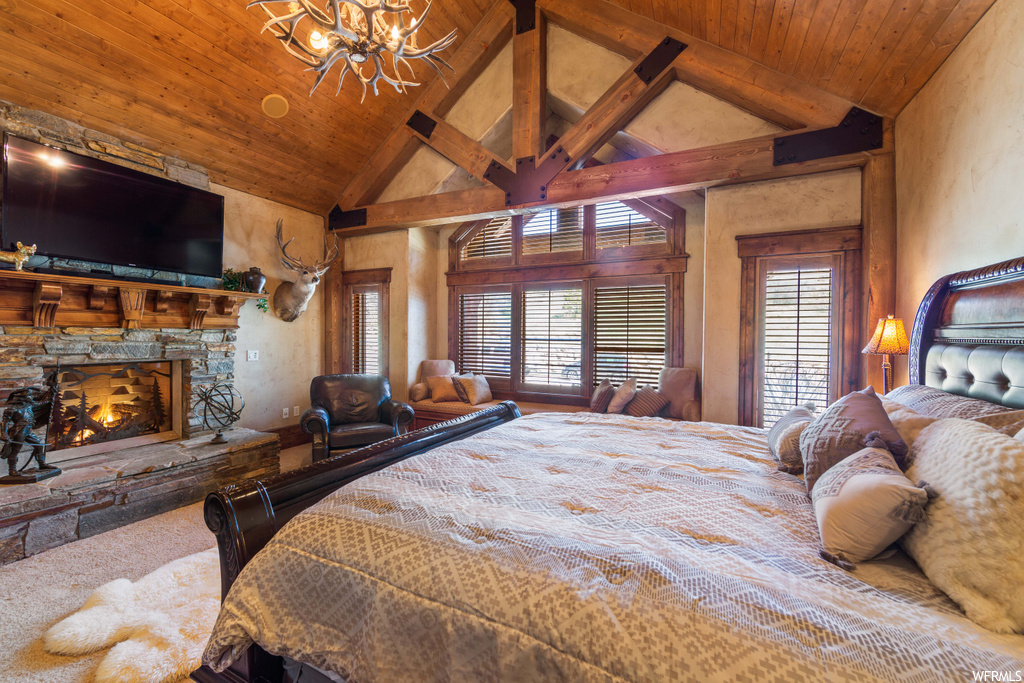 bedroom with vaulted ceiling with beams and TV