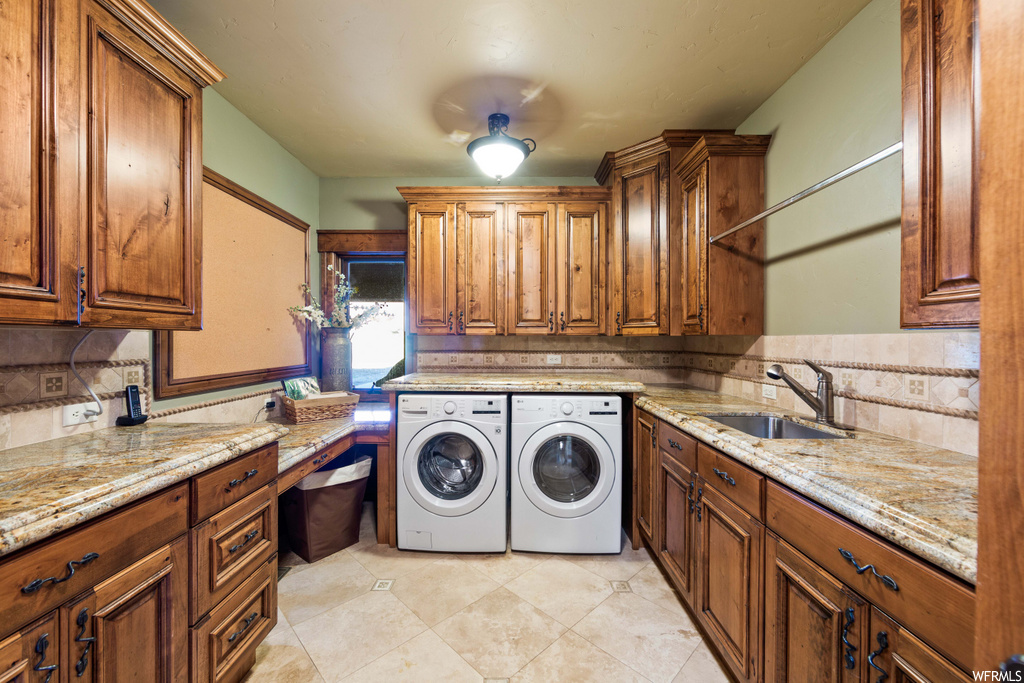 laundry room with tile flooring and separate washer and dryer