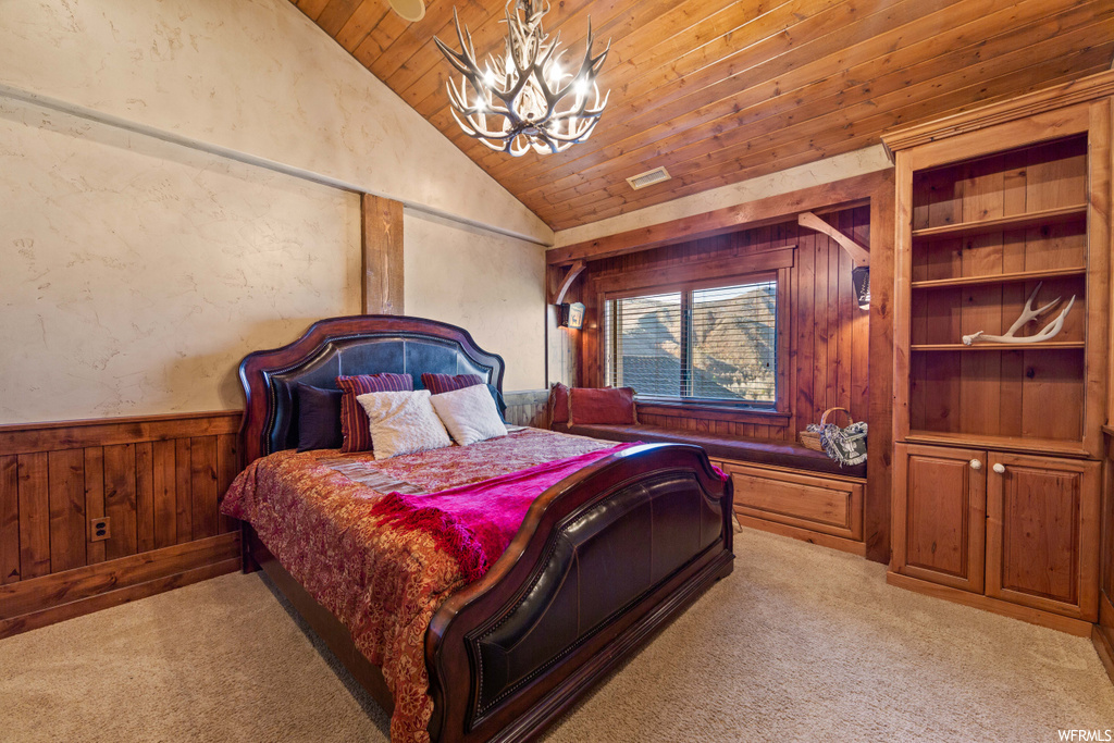 carpeted bedroom featuring natural light, a notable chandelier, and lofted ceiling
