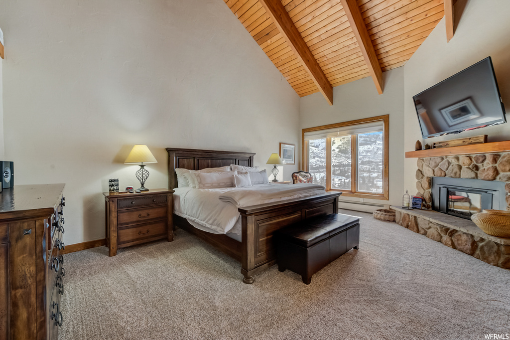 carpeted bedroom with vaulted ceiling with beams and TV