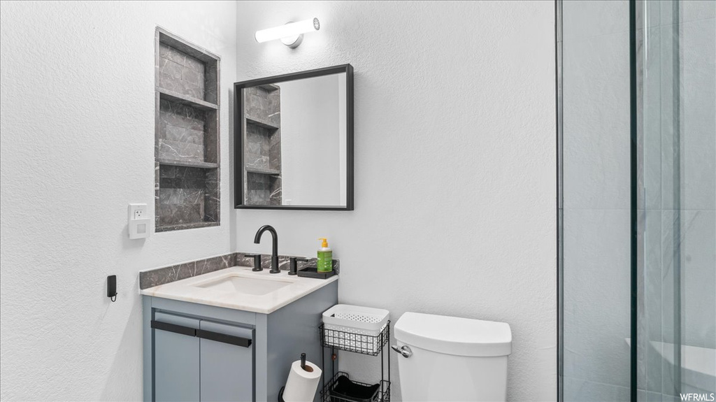 Bathroom with large vanity and toilet