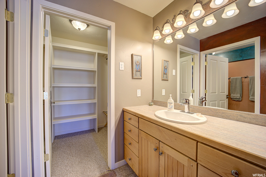 bathroom with vanity and mirror