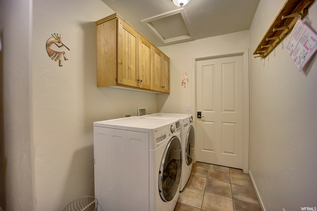 laundry area with tile floors and washer / dryer