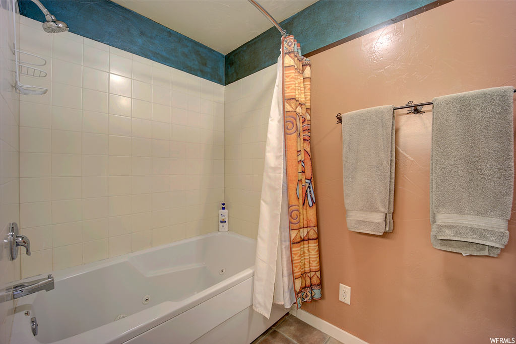 bathroom featuring tile floors, bathtub / shower combination, and shower curtain
