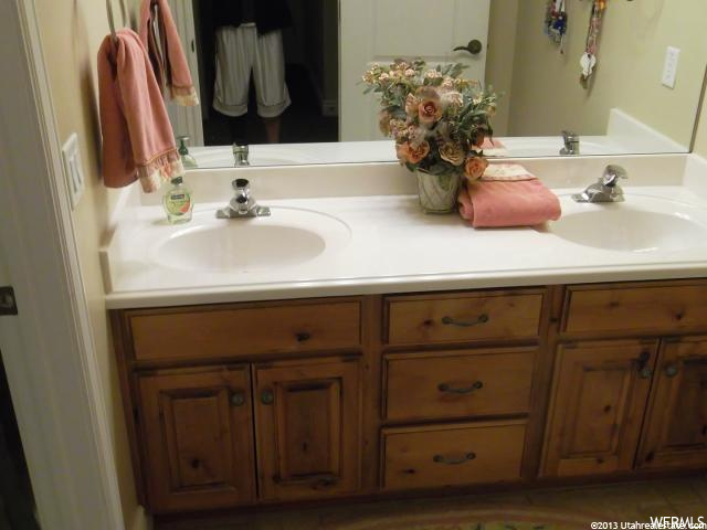 bathroom with mirror and dual large vanity