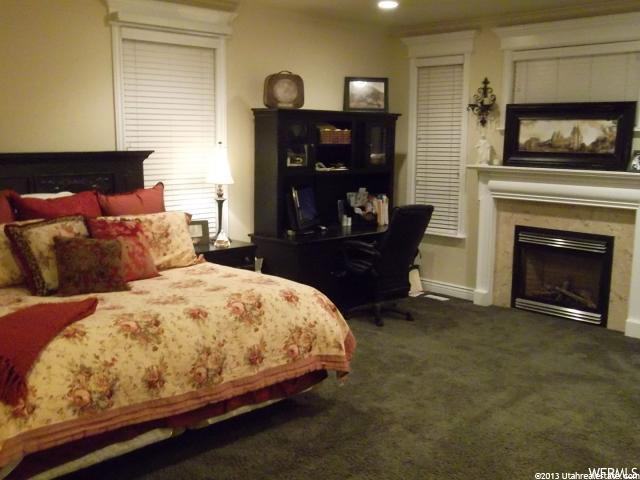 carpeted bedroom with a fireplace
