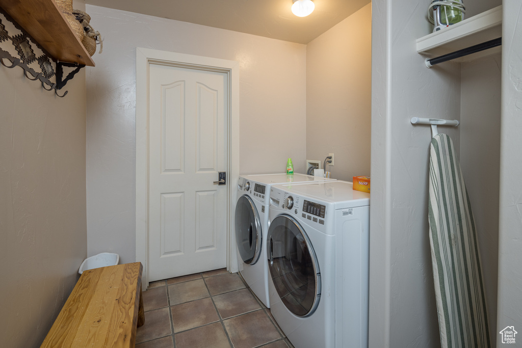 Laundry area with independent washer and dryer, hookup for a washing machine, and tile floors