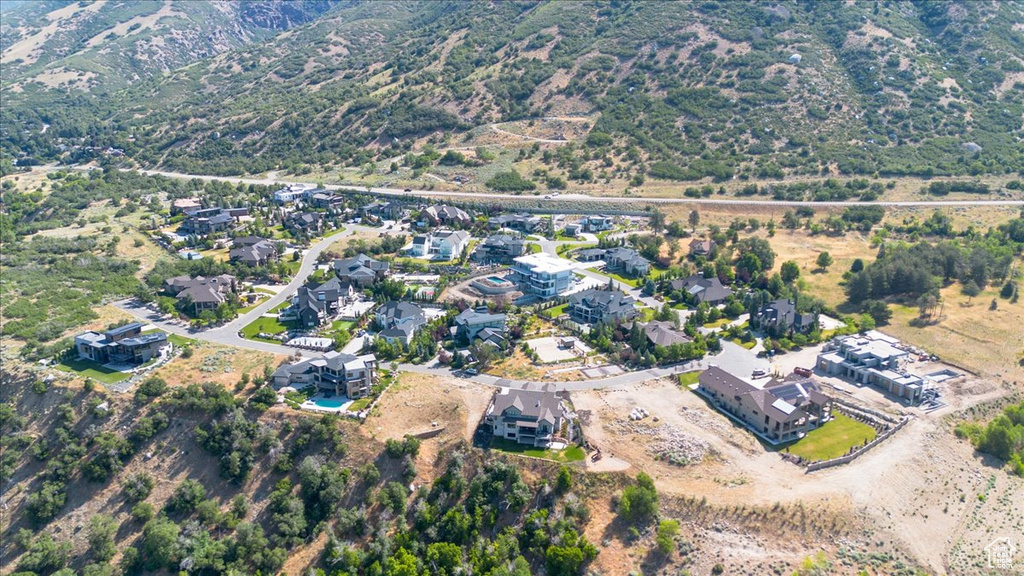 Aerial view of property and surrounding area with nearby suburban area