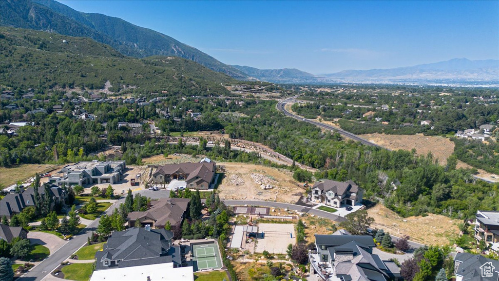 Aerial overview of property's location with mountains and nearby suburban area