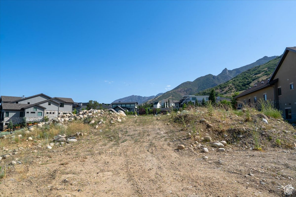 View of mountain backdrop featuring nearby suburban area