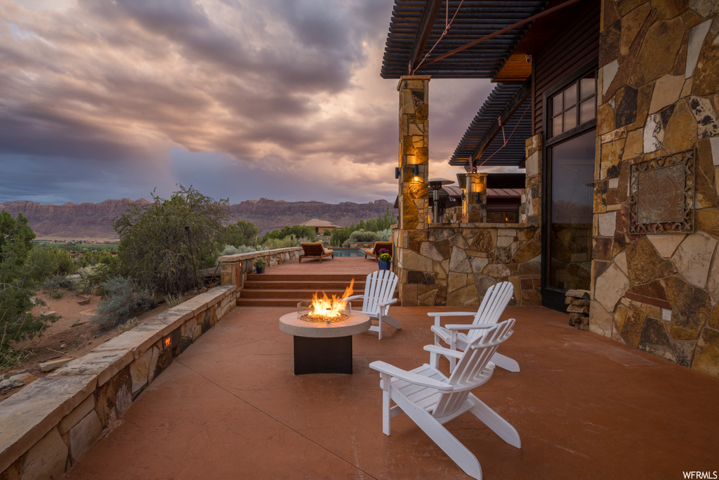 view of terrace featuring a mountain view and fire pit