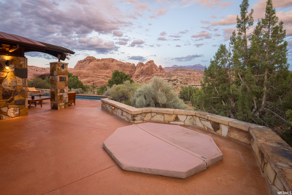 view of patio / terrace with a mountain view and a jacuzzi