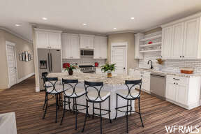 kitchen featuring a center island, a breakfast bar area, stainless steel refrigerator, dishwasher, dark floors, white cabinets, and light countertops