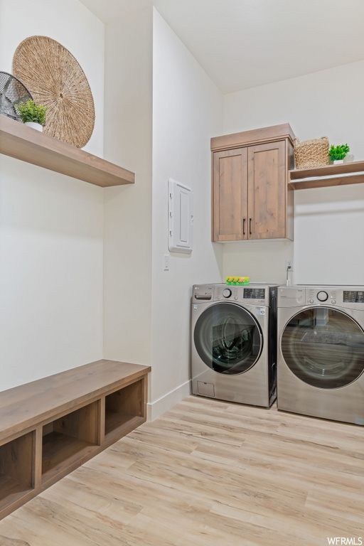 washroom featuring hardwood flooring and independent washer and dryer