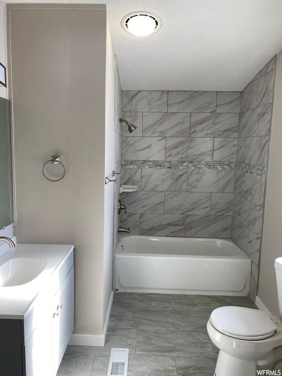 full bathroom with tile floors, toilet, vanity, and bathtub / shower combination
